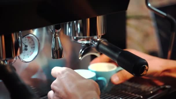 Crop faceless barista preparing coffee in coffeemaker placed on counter in cafe in loft style - Footage, Video