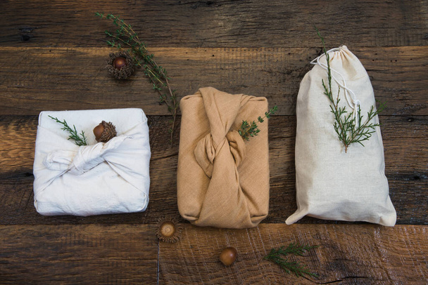 Eco friendly gift wrapping. Earth tones textile holiday. Zero waste holiday season. Japanese style wrapping. Christmas giving. Furoshiki - Photo, Image