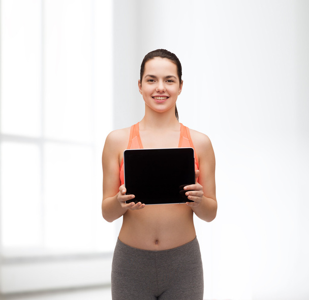 Sporty woman with tablet pc blank screen - 写真・画像