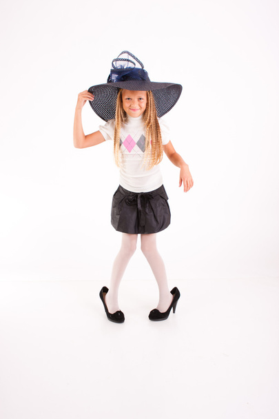 Funny girl in big hat and mum's shoes, isolated on white - Foto, afbeelding