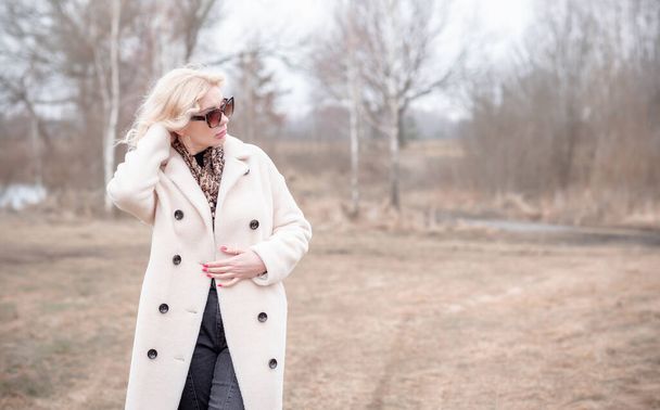 Woman in white fur coat jacket , leopard scarf, cat eye glasses, portrait of blonde nice lady, trendy concept - Photo, Image