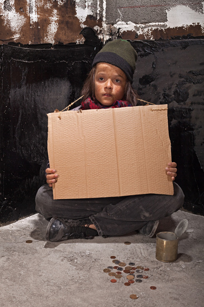 Poor beggar boy on the street with a cardboard sign - Photo, Image