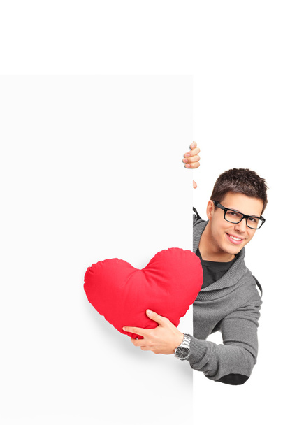 Male holding heart shaped pillow - Φωτογραφία, εικόνα
