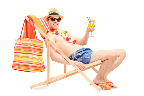 Male on beach chair drinking cocktail - Photo, image