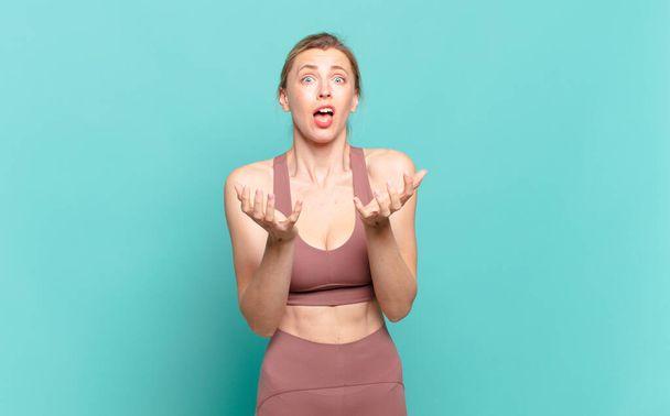 young blond woman looking desperate and frustrated, stressed, unhappy and annoyed, shouting and screaming. sport concept - Photo, image
