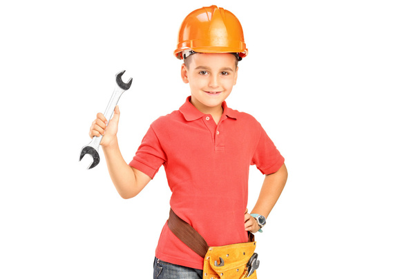 Child with helmet holding wrench - Foto, immagini