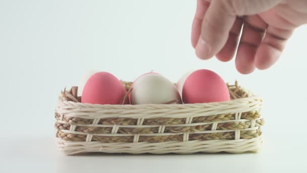 Hand of man took duck's egg in a wooden basket on white background. - Footage, Video