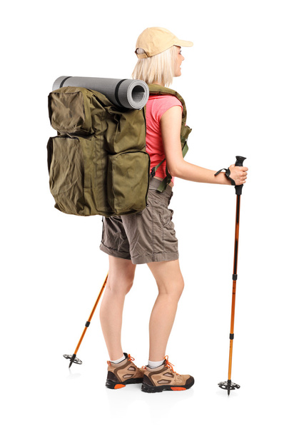 Woman with backpack and hiking poles - Foto, afbeelding