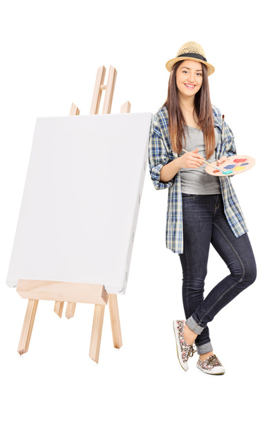 Female artist leaning on a blank canvas  - Foto, imagen