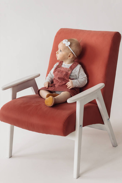 cute little baby girl sitting on chair - Fotografie, Obrázek