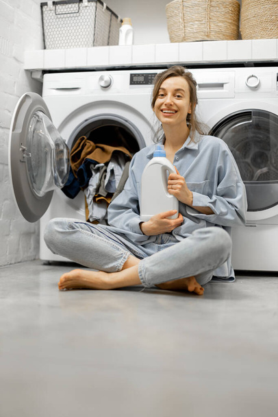 Woman in the laundry room at home - Foto, Imagen