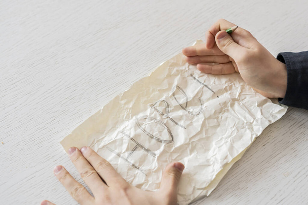 una persona manos sosteniendo una hoja de papel con la palabra esperanza - Foto, imagen