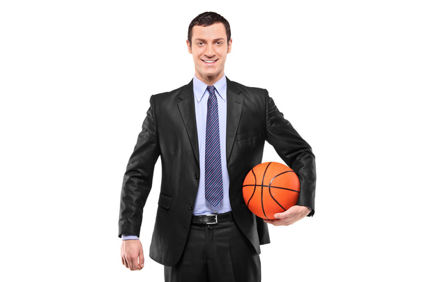 Smiling businessman holding basketball - Fotó, kép