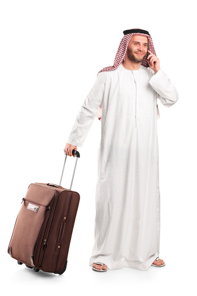 Arab tourist carrying suitcase - Foto, afbeelding
