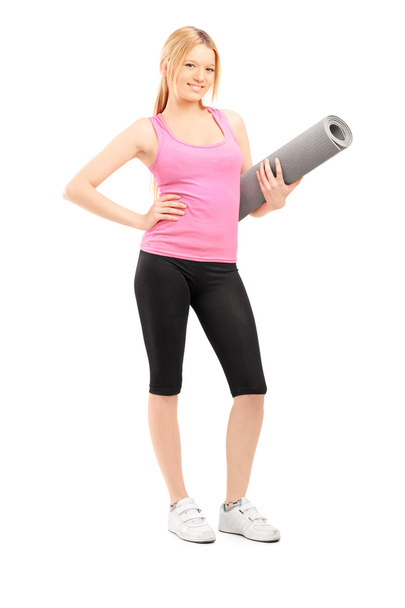 Female with an exercising mat - Фото, зображення
