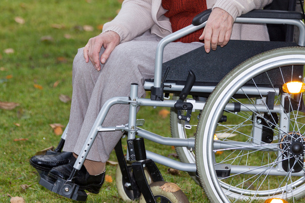 Disabled person on wheelchair outdoors - Fotoğraf, Görsel