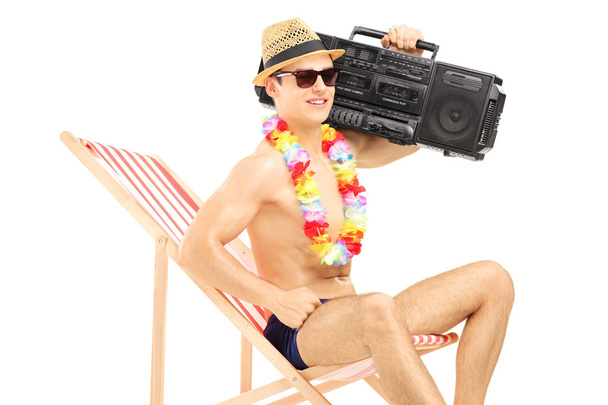 Male tourist on chair with boombox - Photo, Image