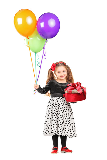 Girl holding gift and balloons - Фото, изображение