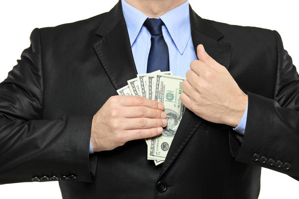 Businessman putting money in his pocket - 写真・画像