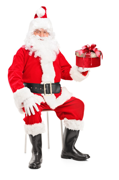 Smiling Santa Claus holding present - Photo, image