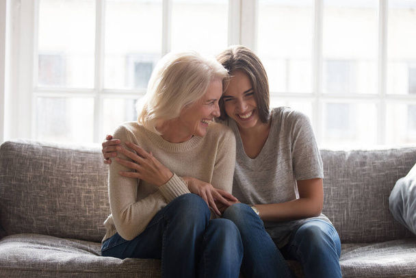 Happy senior mother and adult daughter relax at home - Foto, Imagen