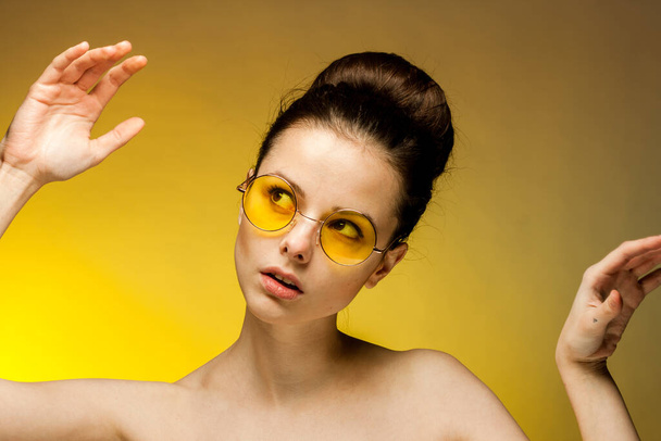 pretty brunette naked shoulders yellow glasses glamor studio - Фото, зображення