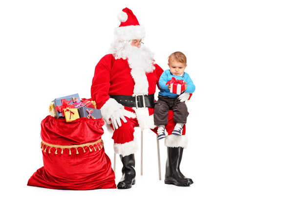 Papá Noel y el niño con regalo
 - Foto, imagen