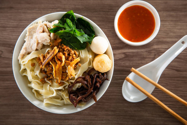 Pan Mee is made with a simple flour-based dough, with anchovy broth, and topped with crispy fried anchovies, ground pork, shiitake mushrooms, and some vegetables. - Photo, Image