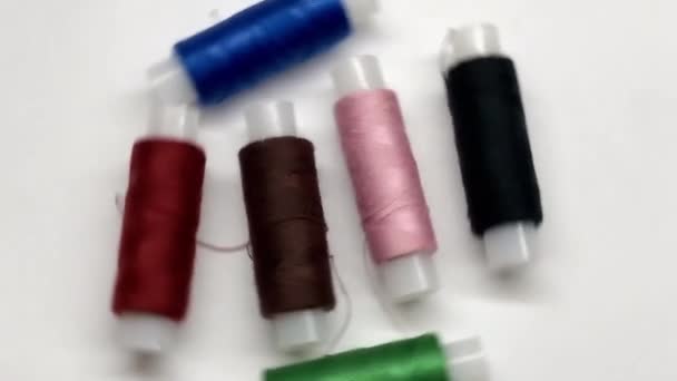 Multicolored skeins of thread on a white background. Spinning objects. Rotating objects - Footage, Video