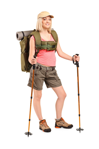 Woman with backpack and hiking poles - Valokuva, kuva