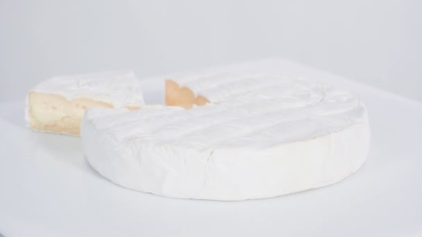 Large slice of gourmet cheese on a white background. - Footage, Video