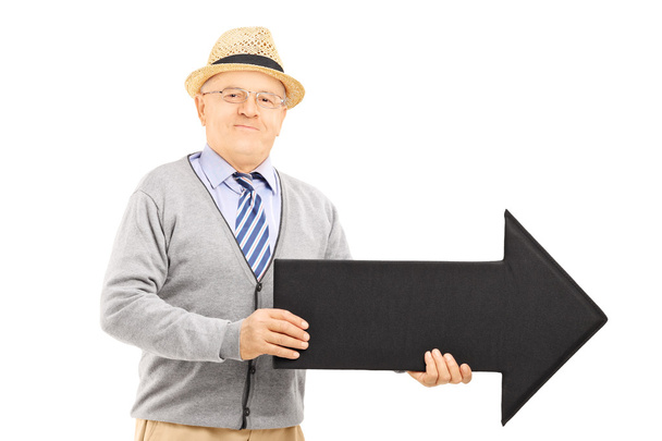 Senior gentleman holding black arrow - Фото, изображение