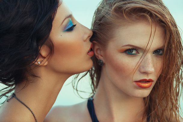 Beautiful couple of models with perfect arty make-up on the beac - Fotó, kép