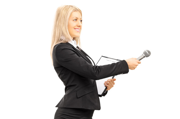 Female interviewer holding a microphone - Foto, Imagem