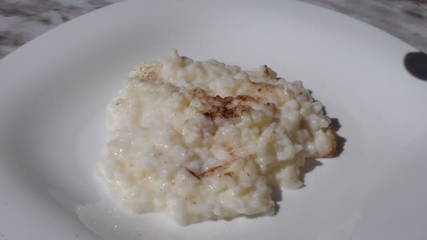 Cook preparing rice pudding, cinnamon and mint - Footage, Video