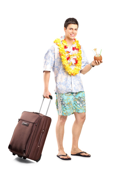 Man with cocktail carrying luggage - Φωτογραφία, εικόνα