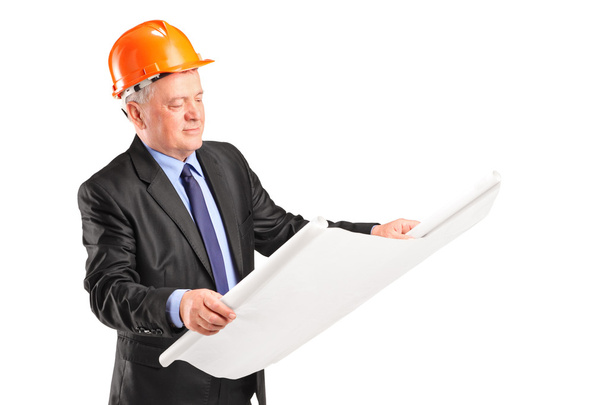 Mature construction worker holding blueprint - Foto, imagen