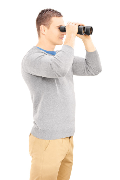 Casual man looking through binocular - Zdjęcie, obraz