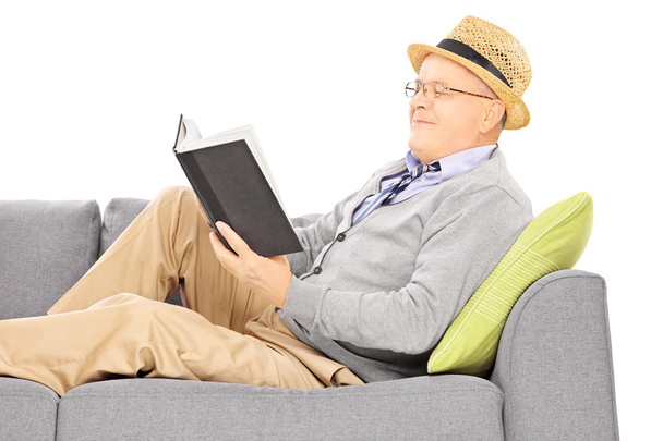 Senior man reading a novel - Фото, зображення