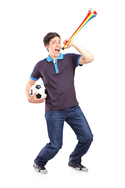 Sport fan holding football and horn - Foto, afbeelding
