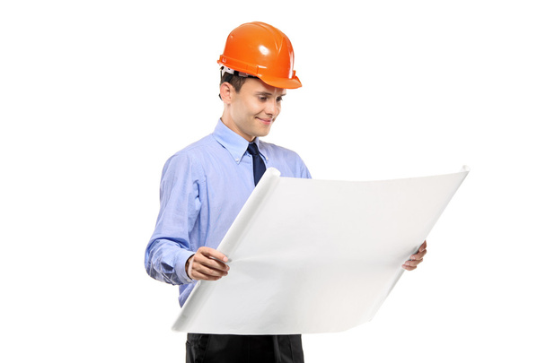 Construction worker looking at blueprints - Zdjęcie, obraz