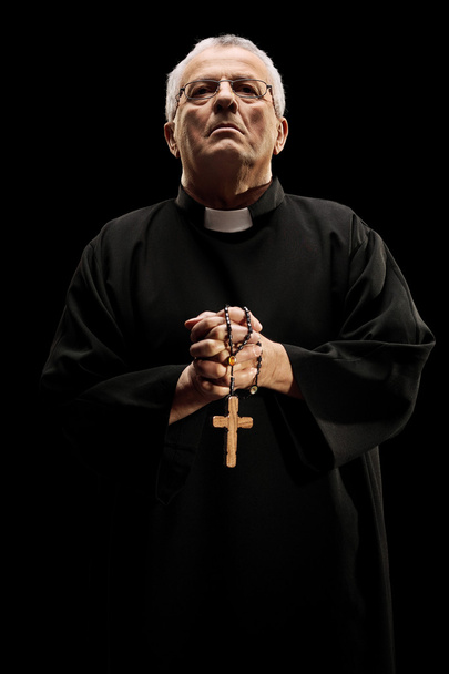 Catholic reverend holding wooden cross - Фото, зображення