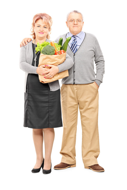 Mature couple holding paper bag - Foto, afbeelding