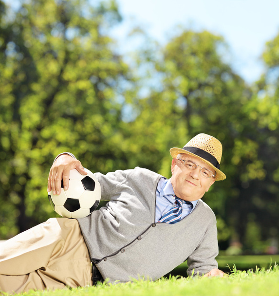 Senior man on grass with ball - Фото, изображение