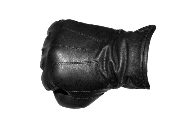 A clenched fist in a leather glove on a white background. - Photo, Image