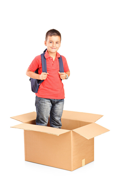 Child with backpack in cardbox - Foto, Bild