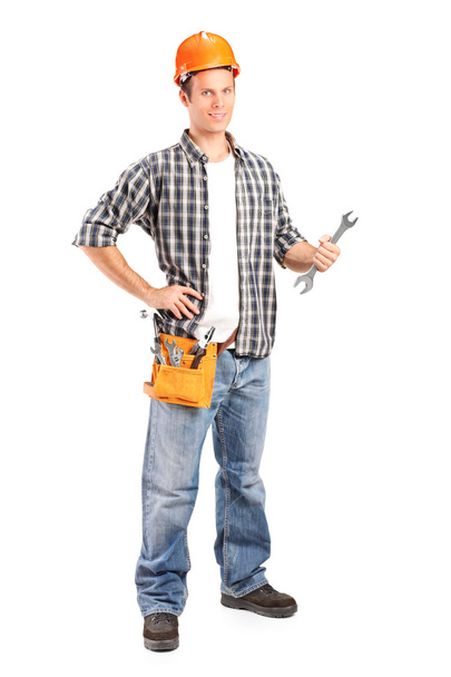 Smiling handyman holding wrench - Foto, imagen