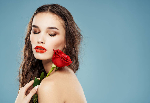 Side view of woman with naked shoulders and red flower - Photo, Image