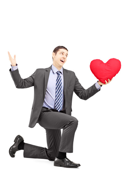 Male in suit kneeling with heart - Photo, Image