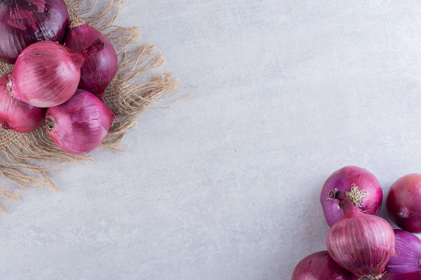 ripe organic onions on kitchen table  - Fotó, kép